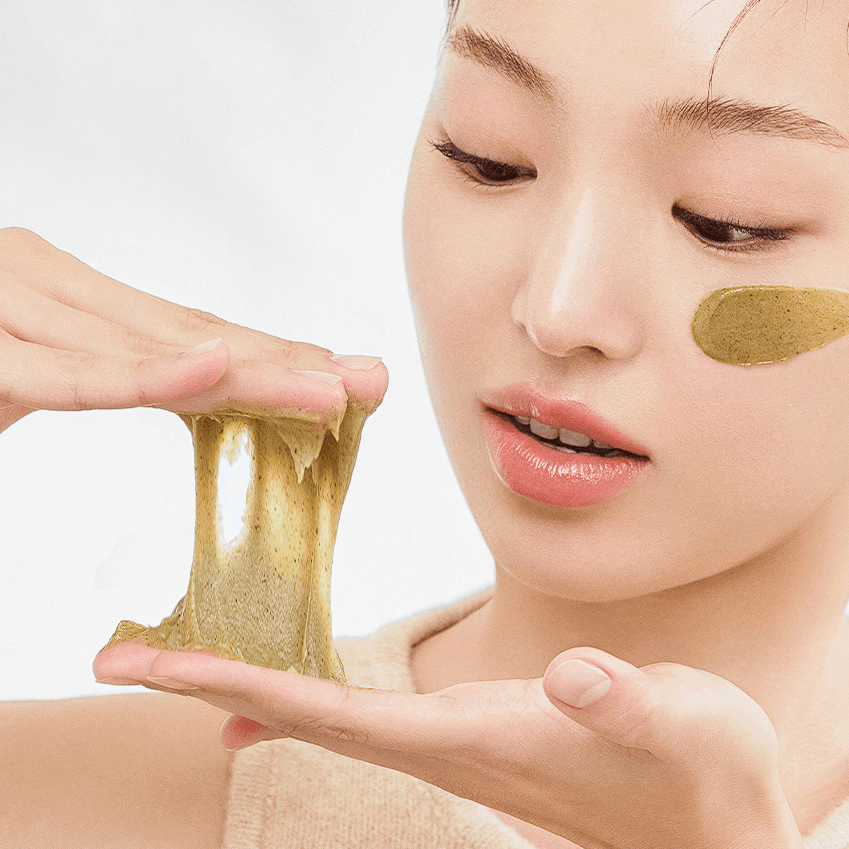 Woman applying HANYUL Young Mugwort Cleansing absorption Pack Foam on skin, demonstrating texture and use