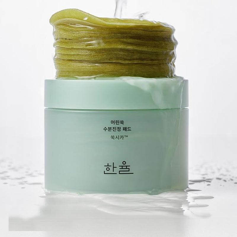 HANYUL Young Mugwort Moisturizing Soohting Pad in green jar with stack of soothing pads; skincare product promotion