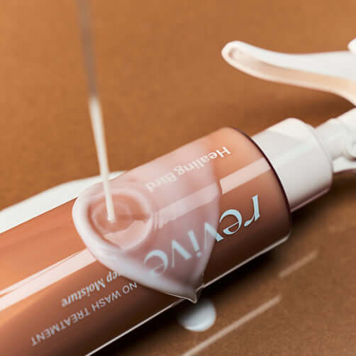 HEALING BIRD Revive No-Wash Treatment Ultra Shine Plan 200ml bottle with liquid being poured, enhancing hair shine and moisture.