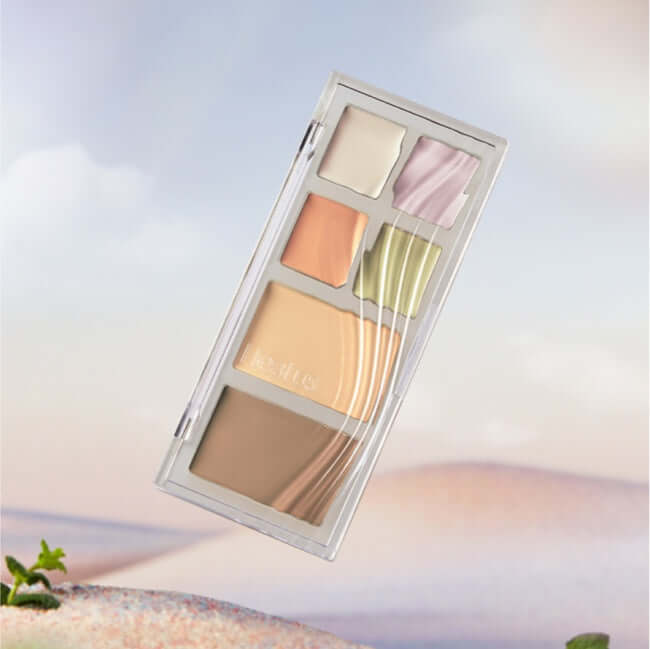 HEALUS Breath Concealer Palette displayed against a soft landscape background with various concealer shades.