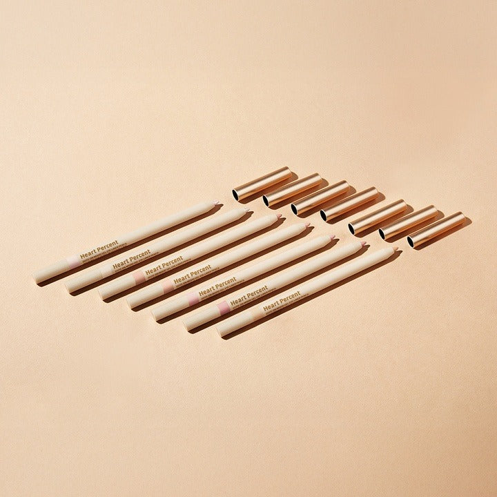 HEART PERCENT Dot On Mood Gel Eyeliner Pencil displayed with multiple open caps on a beige background