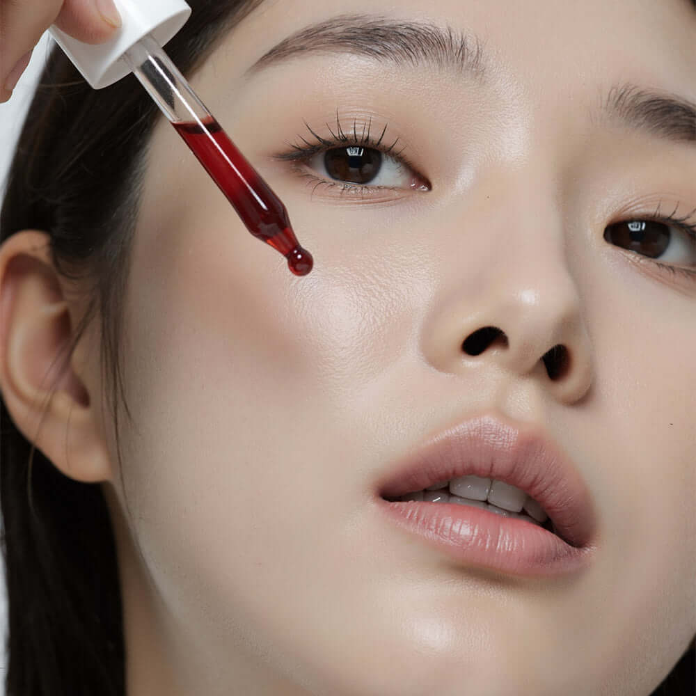 Model applying HEIMISH RX AHA BHA Peeling Serum 35ml on skin using a dropper, showcasing skincare routine benefits.