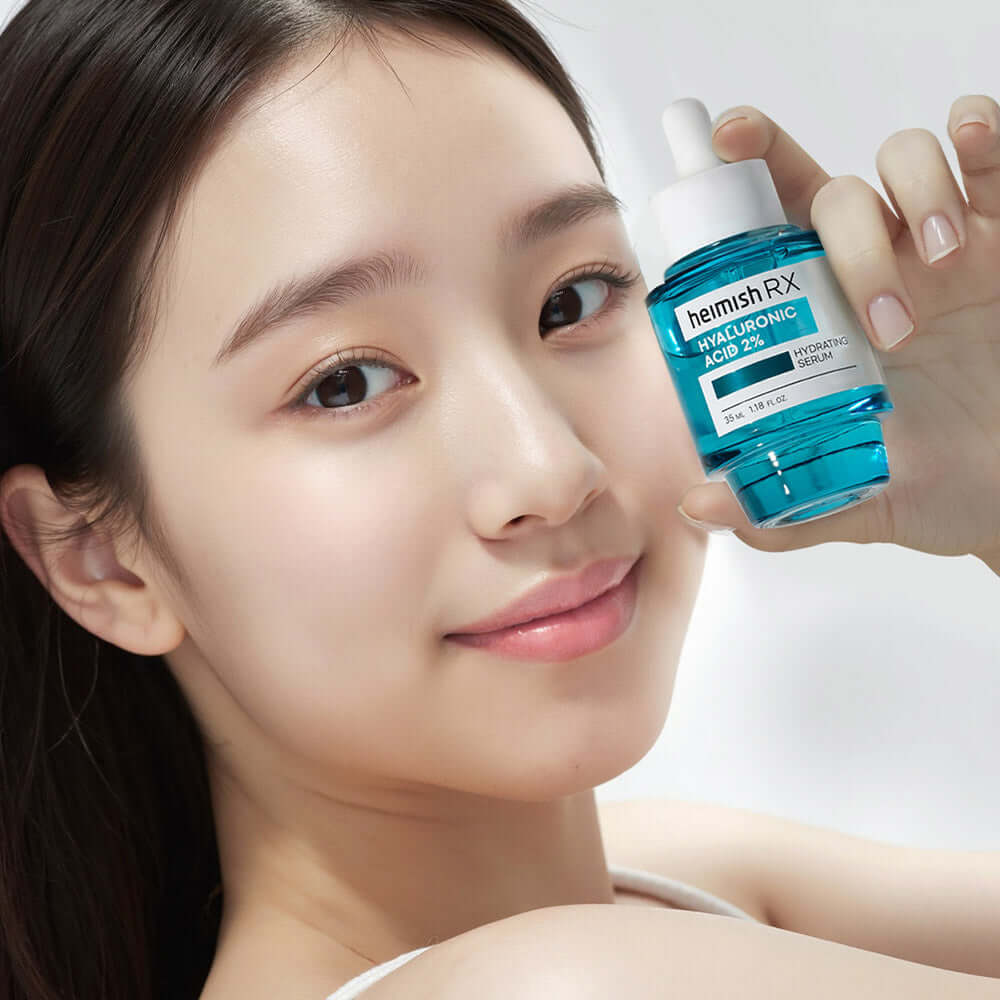 Smiling person holding HEIMISH RX Hyaluronic Acid Hydrating Serum 35ml bottle, showcasing hydration skincare product.