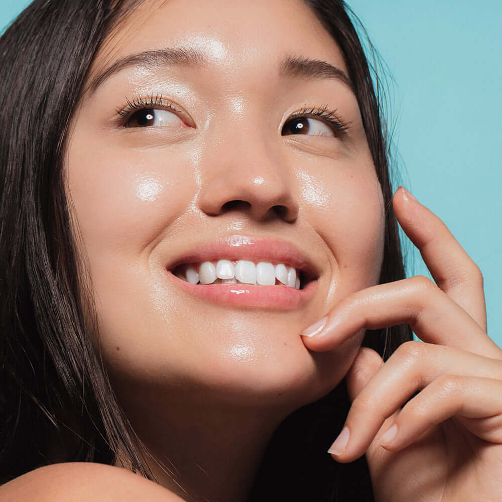 Woman with radiant skin using HEIMISH RX Hyaluronic Acid Hydrating Sunscreen SPF50+ PA++++