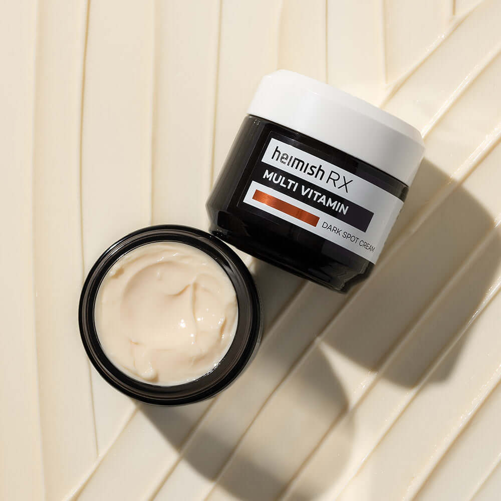 Open jar of HEIMISH RX Multi Vitamin Dark Spot Cream 50ml on a textured background.