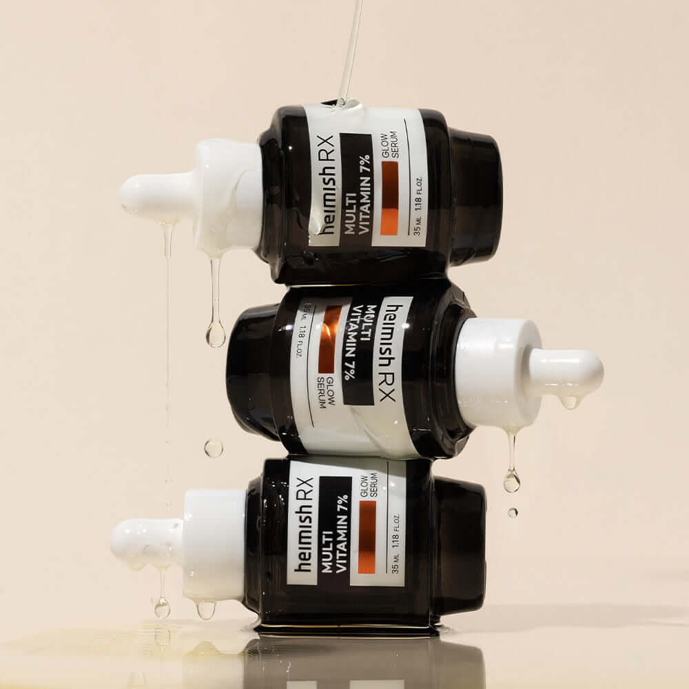 Stacked bottles of HEIMISH RX Multi Vitamin Glow Serum 35ml, showcasing its vibrant formula and sleek packaging design.