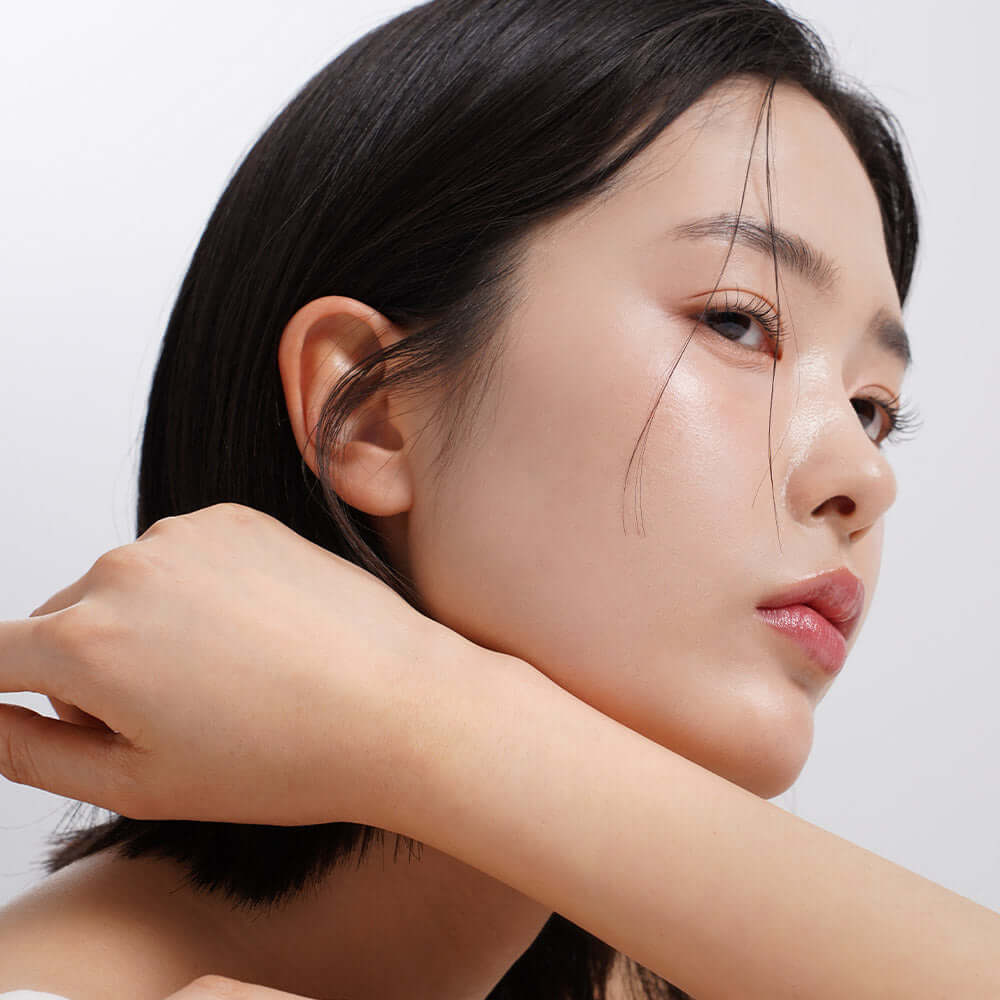 Woman with glowing skin using HEIMISH RX Retinol Bakuchiol Eye Cream 30ml