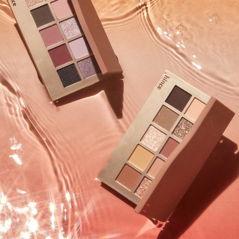 HINCE New Depht Eye Shadow Palette with shimmering shades on a reflective surface