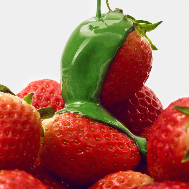 Fresh strawberries with green matcha glaze, related to HIT THE TEA Super Matcha Strawberry Rool Cake Gluten-Free.