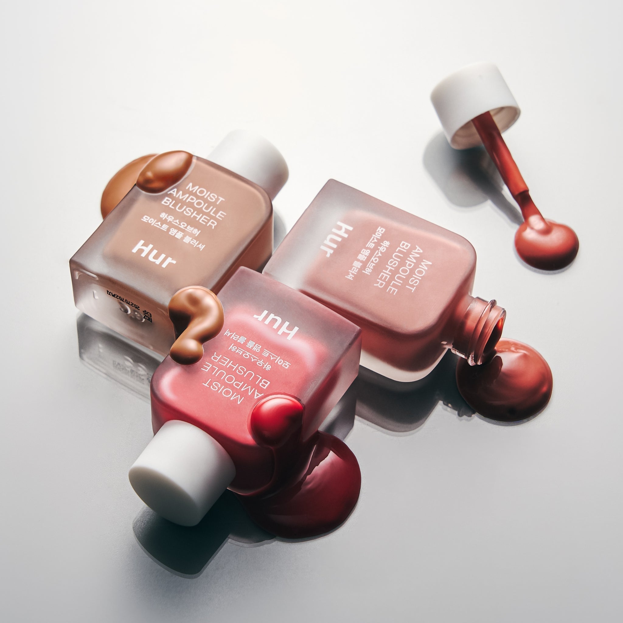 HOUSE OF HUR Moist Ampoule Blusher 10ml bottles with creamy texture on a reflective surface