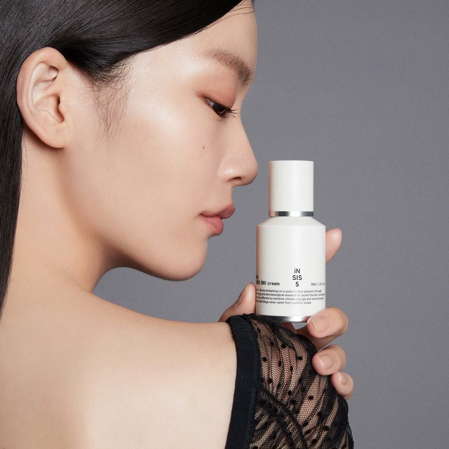 HUXLEY Biosys 360 Cream held by a woman showcasing skincare product