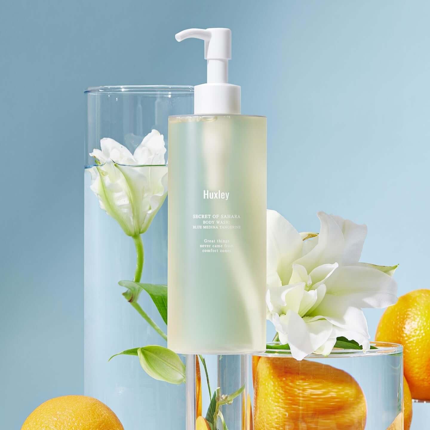 HUXLEY Body Wash Blue Medina Tangerine with citrus and floral backdrop