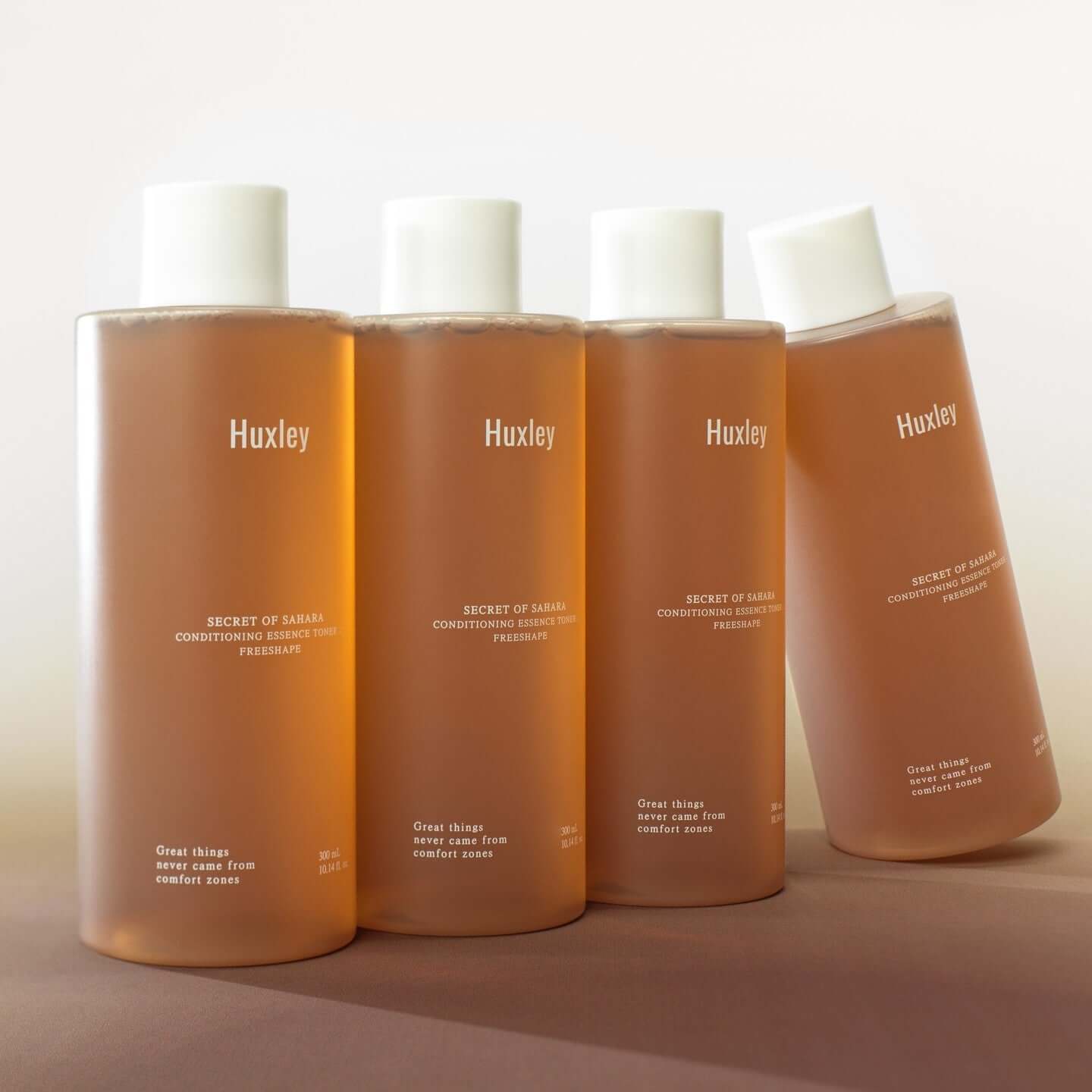 HUXLEY Conditioning Essence Toner Preshape bottles in a row, showcasing the skincare product
