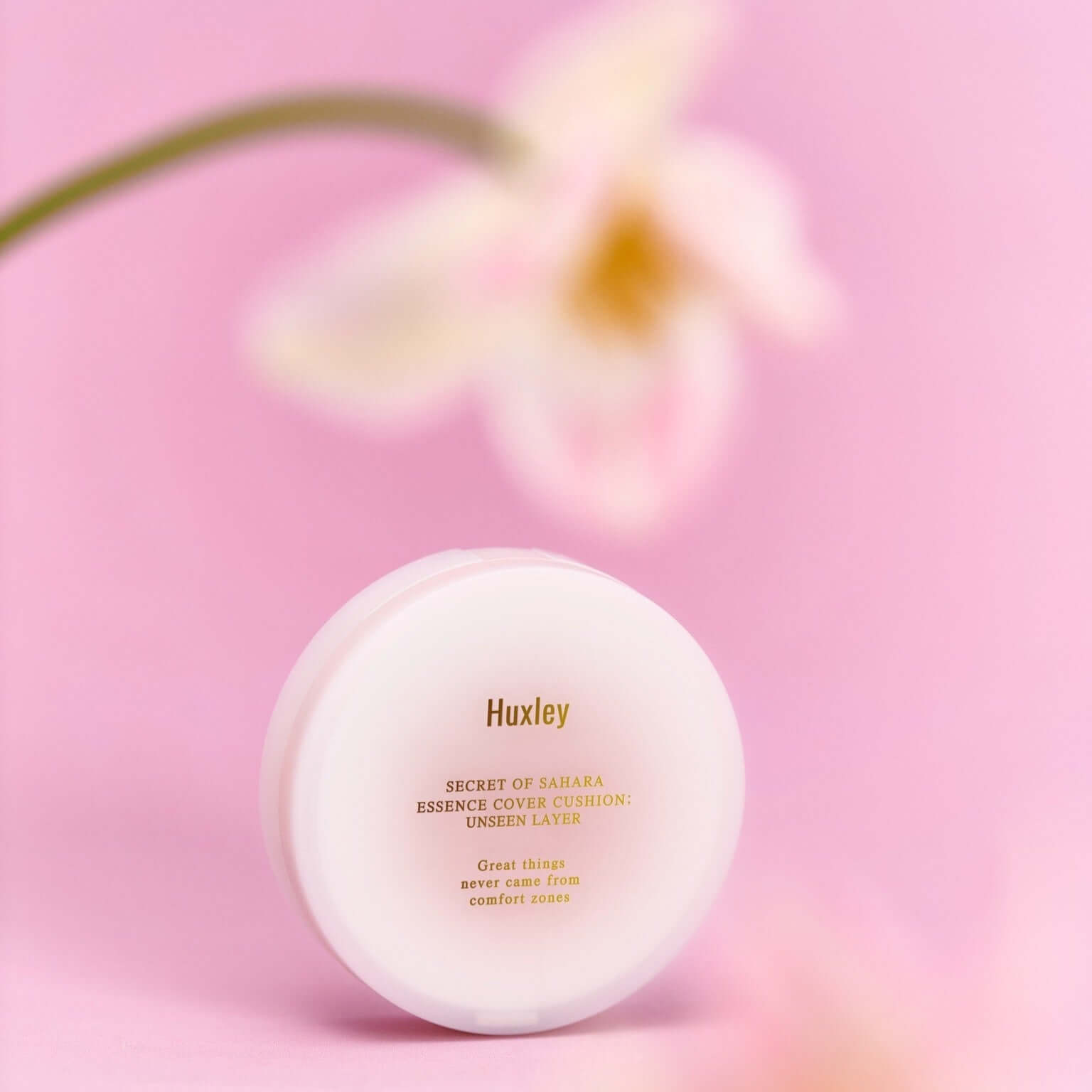 HUXLEY Essence Cover Cushion Unseen Layer with flower background, enhancing natural beauty and moisturization.