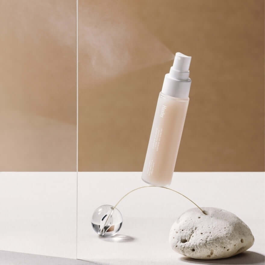 HUXLEY Essential Mist Sense Of Balance bottle showcased on minimalist stone and glass background.