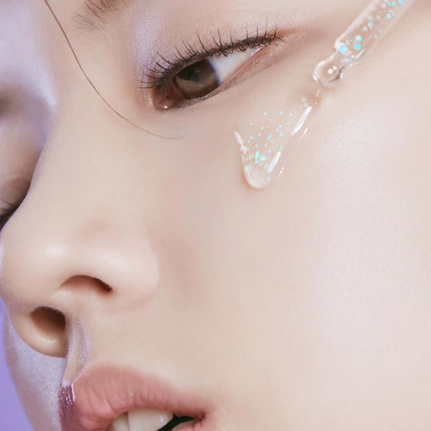 Close-up application of HUXLEY Priming Essence Rediance Layer on skin for enhanced radiance and hydration.