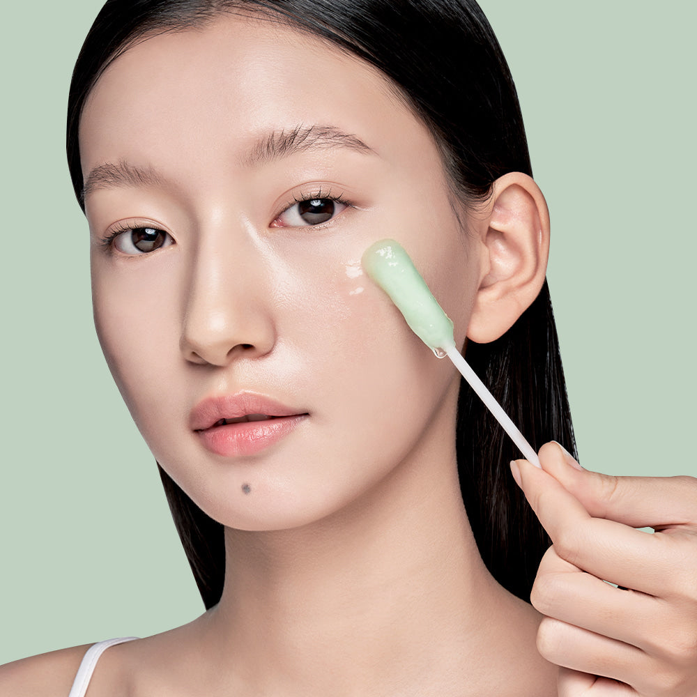 Woman applying ILSO No Trouble Peeling Swab 8 sheets on face for skincare routine