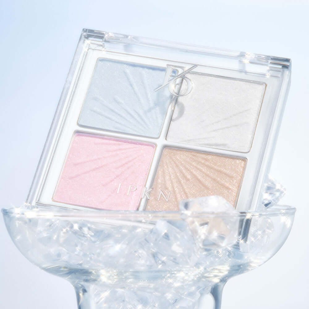 IPKN Flap One Face Palette displayed on ice, showcasing four shimmering shades for versatile makeup looks.