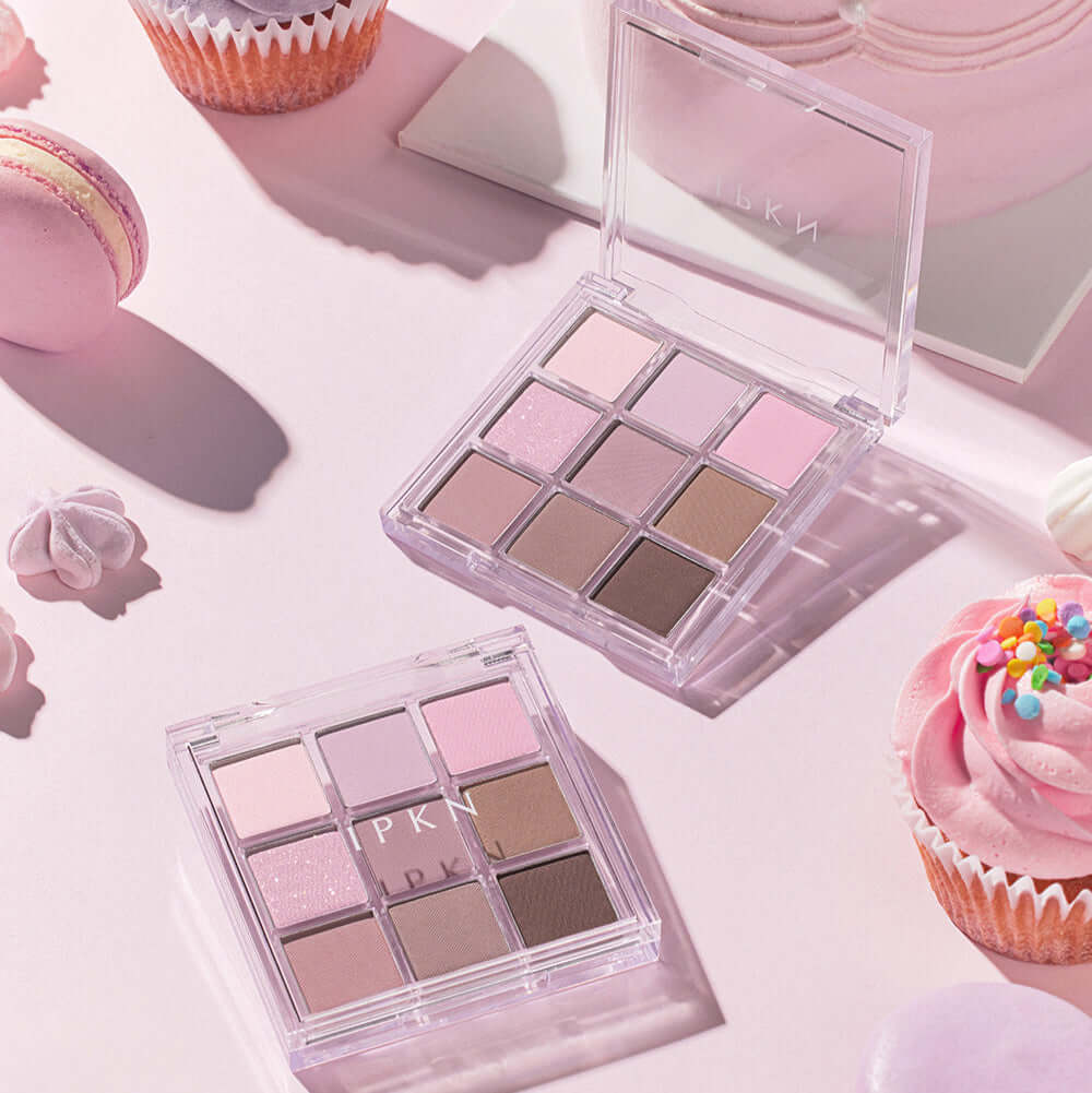 IPKN Personal Mood All Palette Cool Pressed 6.8g next to pastel macarons and cupcakes on a pink background.