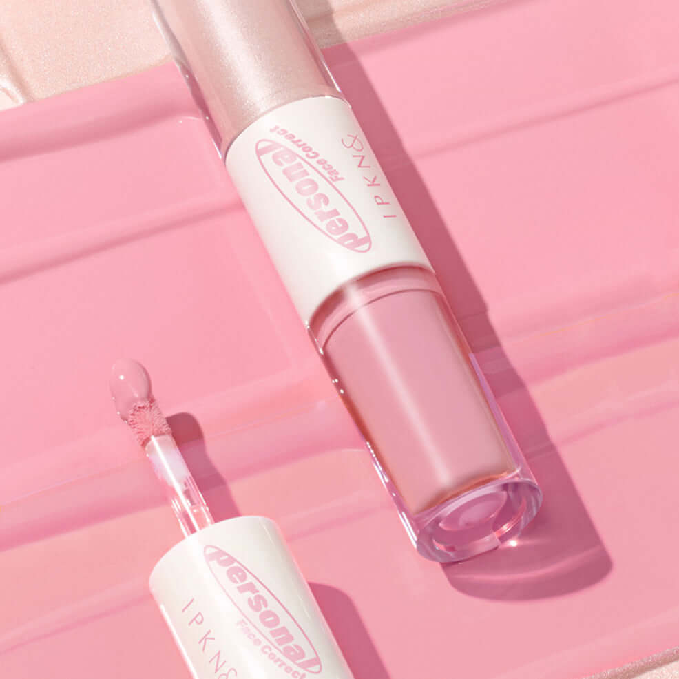 IPKN Personal Tone Cheek Lighter Duo (Cool Lighter) on pink surface highlighting its sleek design and color