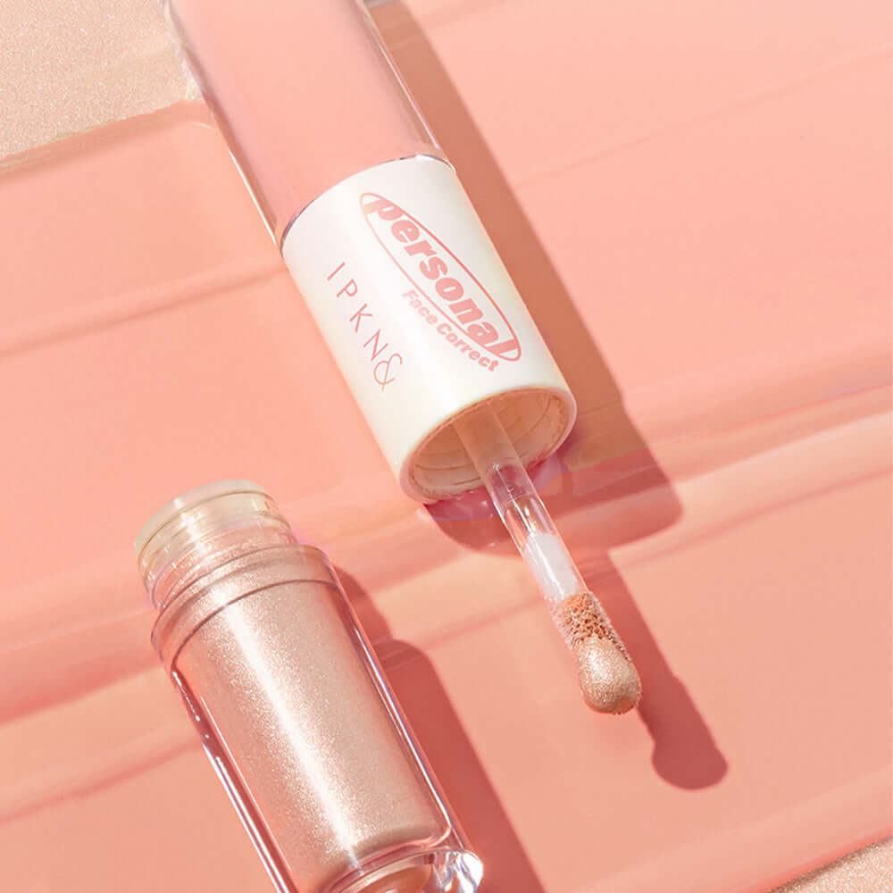 IPKN Personal Tone Cheek Lighter Duo (Warm Lighter) with applicator and open container on peach background