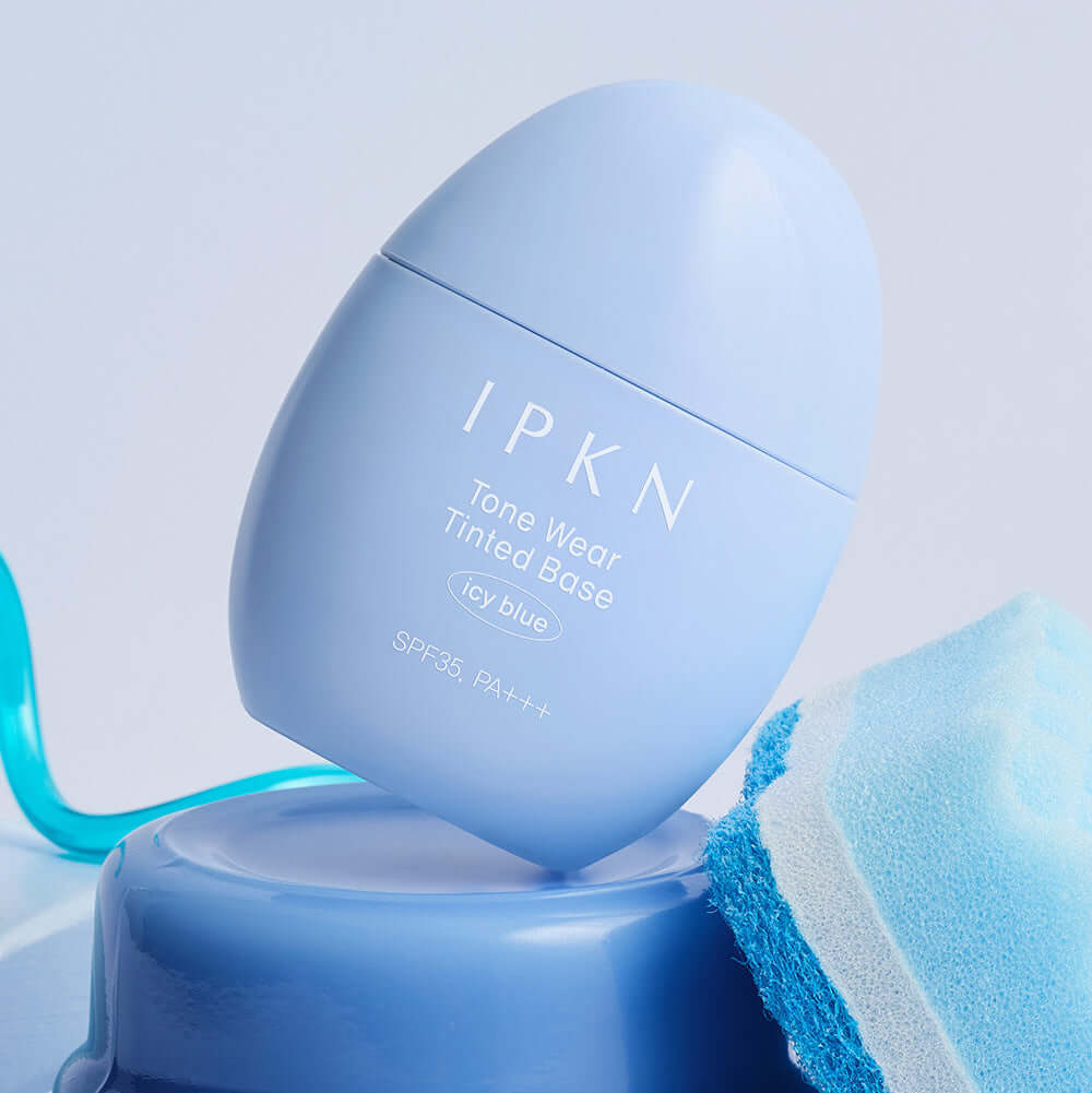 IPKN Tone Wear Tinted Base Icy Blue SPF35 PA++ on a blue background with matching fabric accent