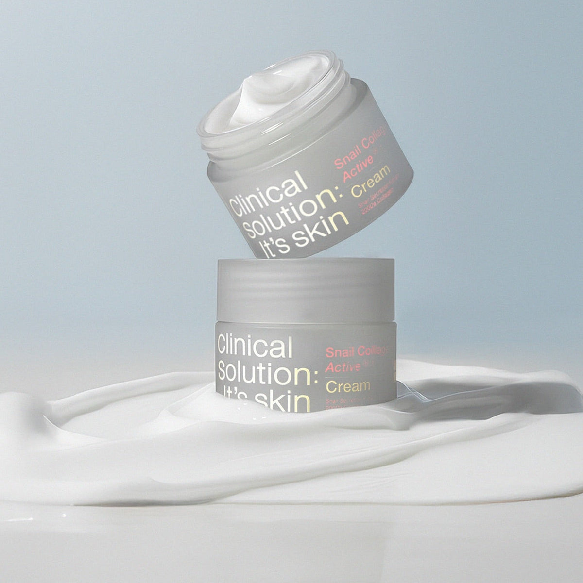 IT'S SKIN Snail Collagen Active Cream 50ml jars on a swirling cream background