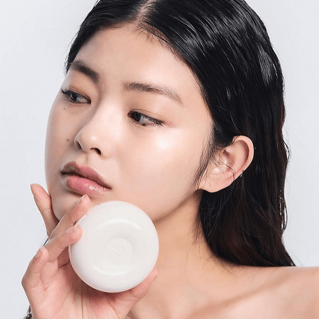 Woman holding IVI MAD PEACH Glazed Glow Cushion skincare product