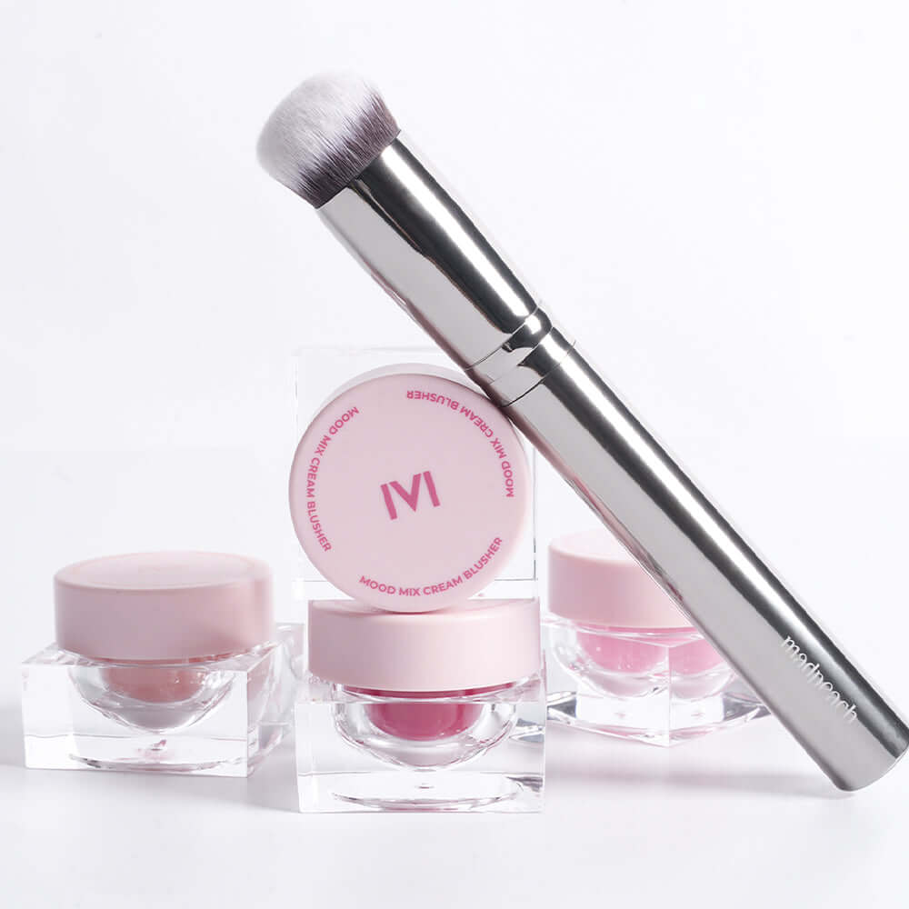 IVI MAD PEACH Soft Touch Makeup Brush with pink cosmetic containers on white background.