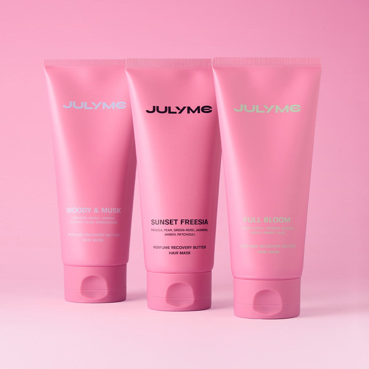 JULYME Perfume No-Wash Repair Hair Pack 150ml elegant pink tubes with various scents on a pink background.