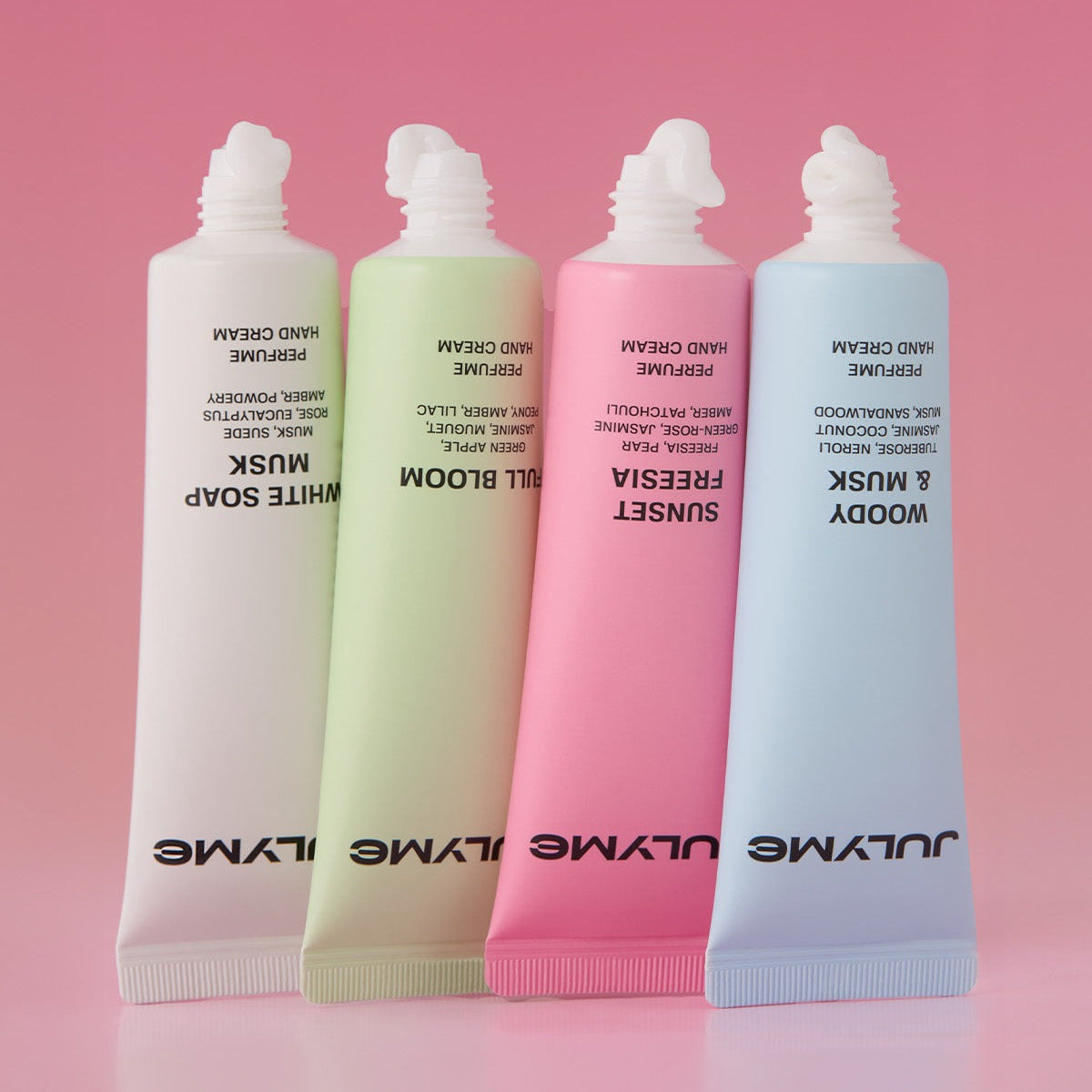 JULYME Perfume Shea Butter Hand Cream 30ml tubes in assorted colors on pink gradient background