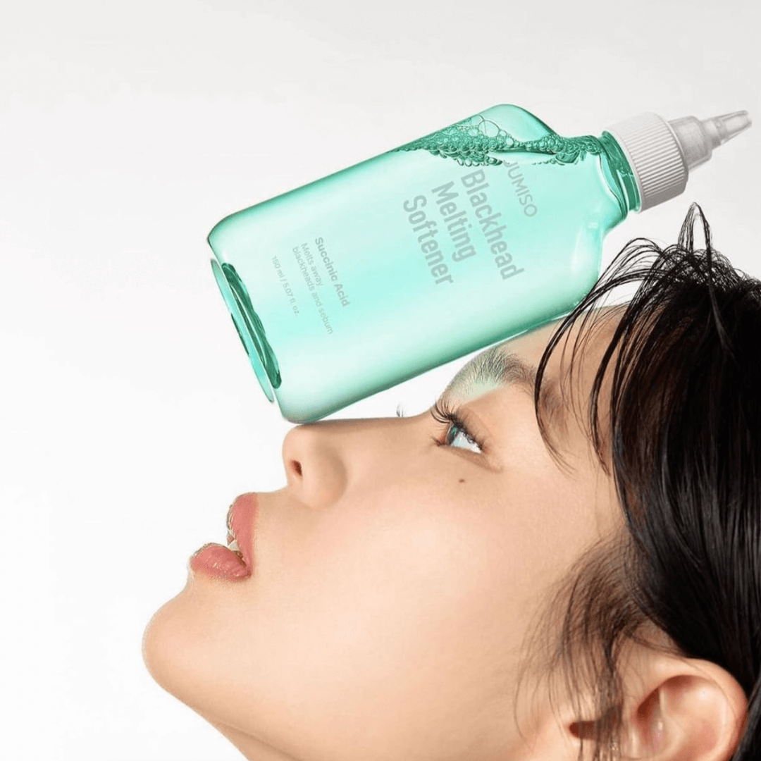 JUMISO Blackhead Melting Softener 150ml bottle balancing on woman's nose showcasing product design and packaging