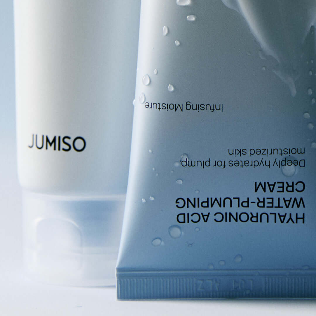 JUMISO Hyaluronic Acid Water Plumping Moisture Cream packaging close-up with water droplets on the tube.
