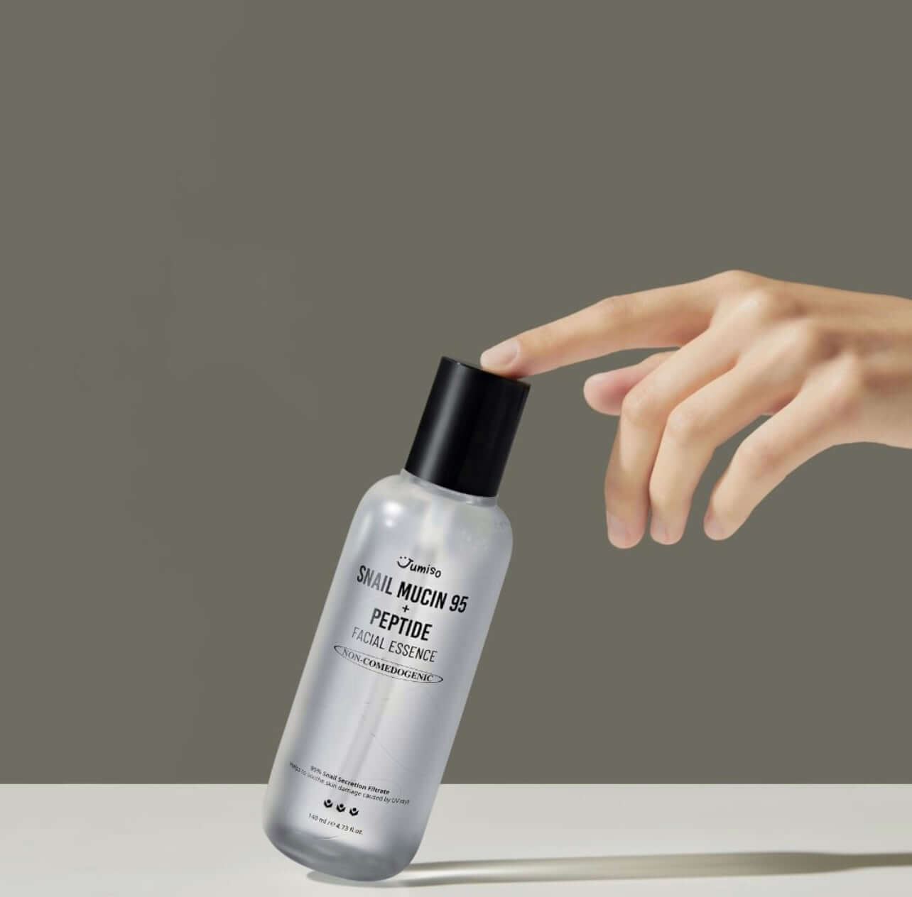 JUMISO Snail Mucin 95+ Peptide Facial Essence 140ml bottle with hand reaching out.