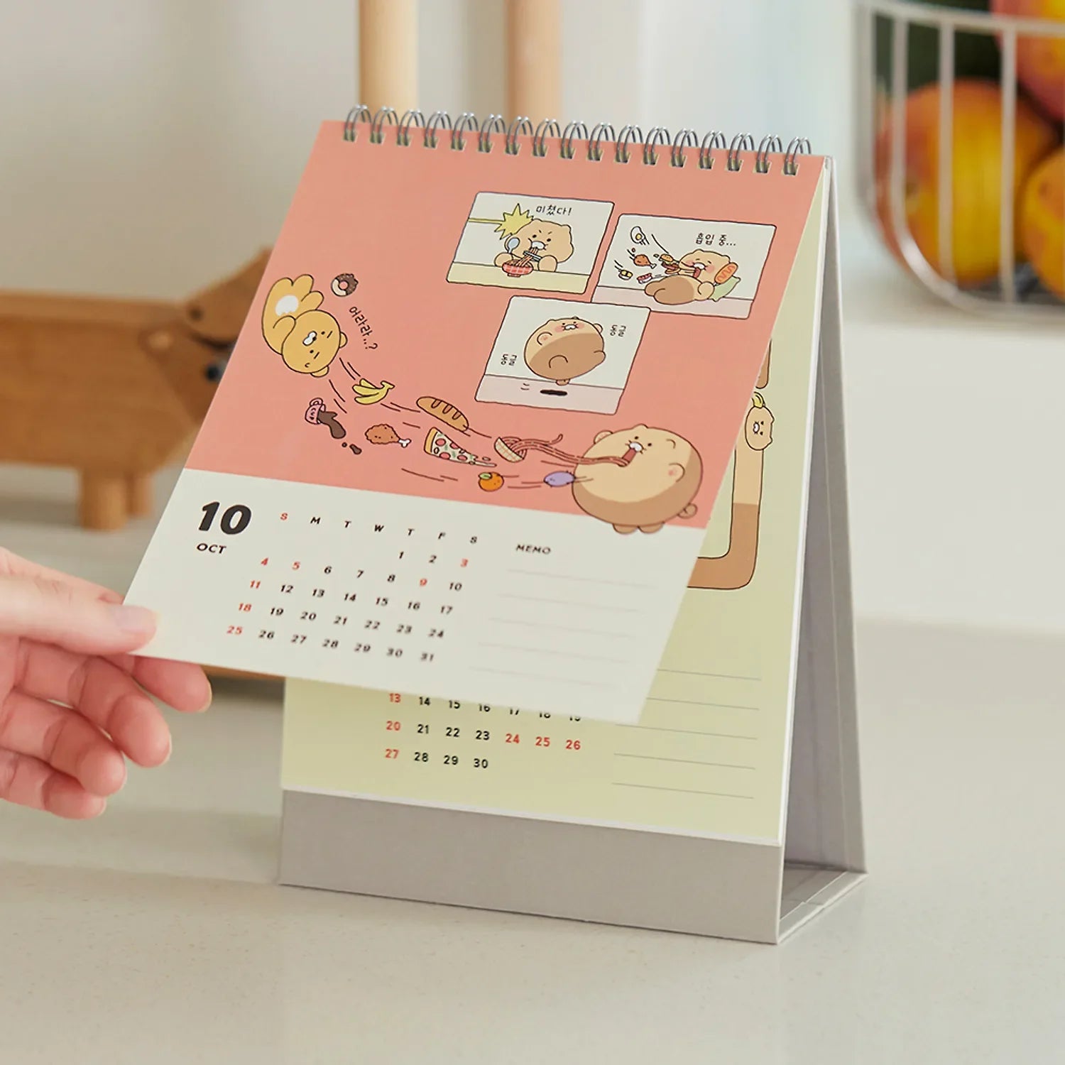 KAKAO FRIENDS Desk Calendar 2026 with cartoon characters on October page in a kitchen setting