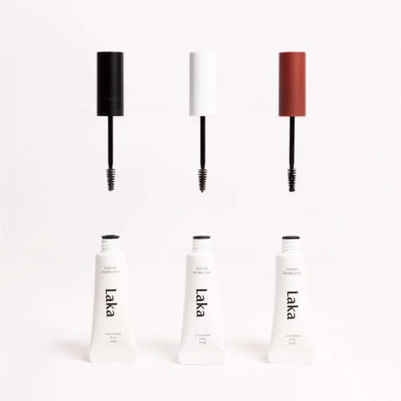 LAKA Wild Brow Shaper in three shades with applicators and packaging displayed elegantly.