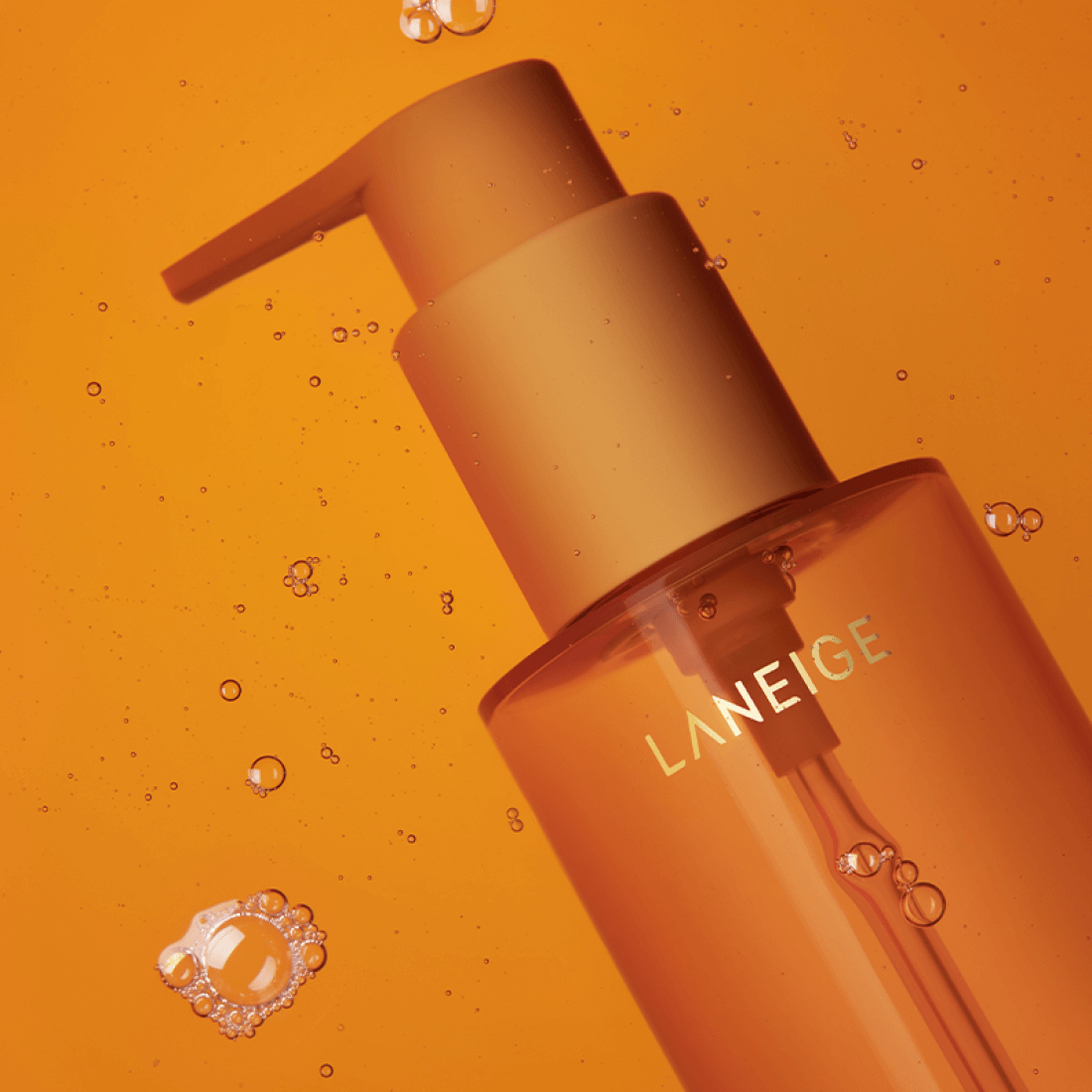 LANEIGE Perfect Renew Nourishing Oil To Foam Cleanser 200ml bottle with pump, orange background with bubbles, skin care product