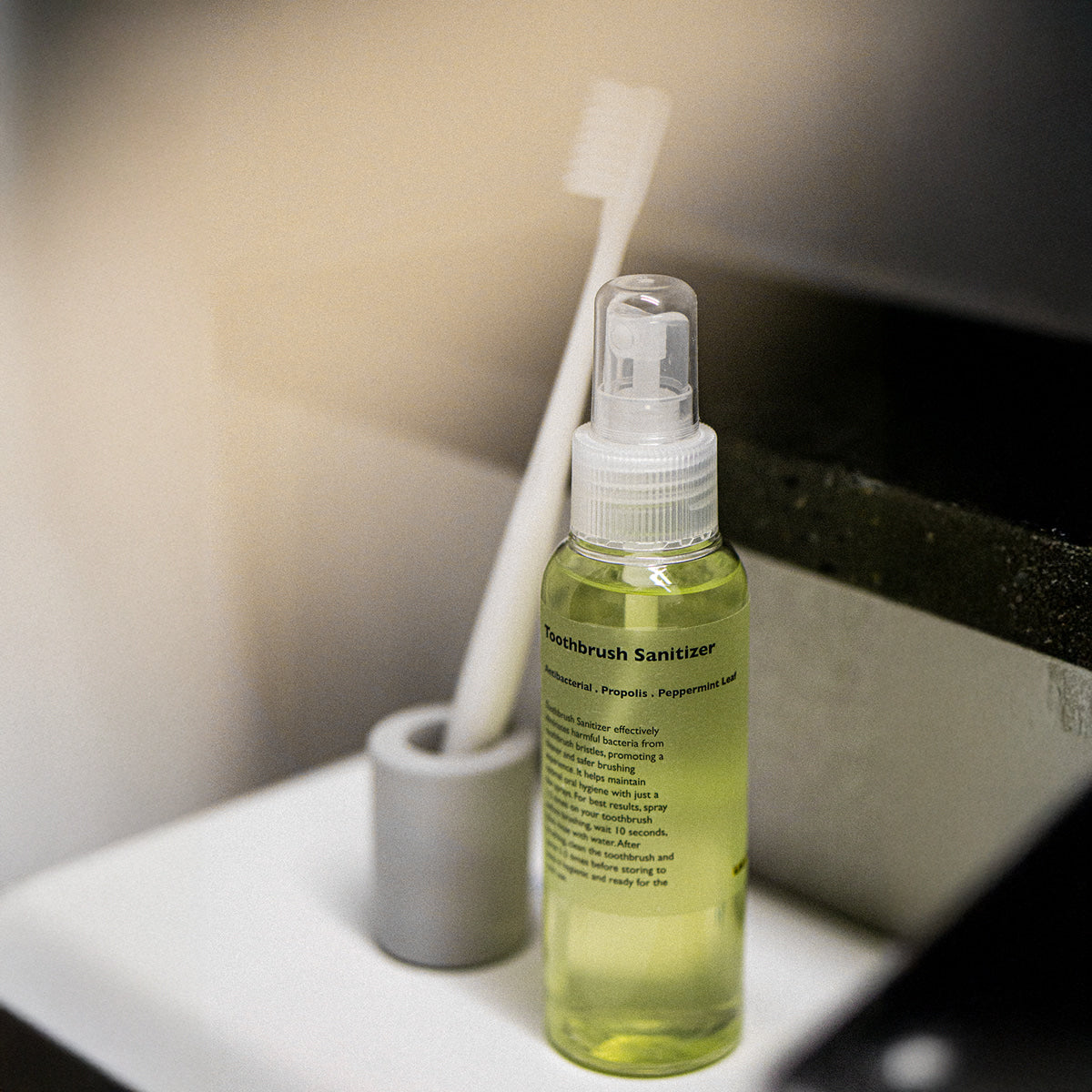 Gentleman Korea product shot of LAZY SOCIETY Toothbrush Sanitizer 100ml bottle next to toothbrush on bathroom counter, Korean skincare for men