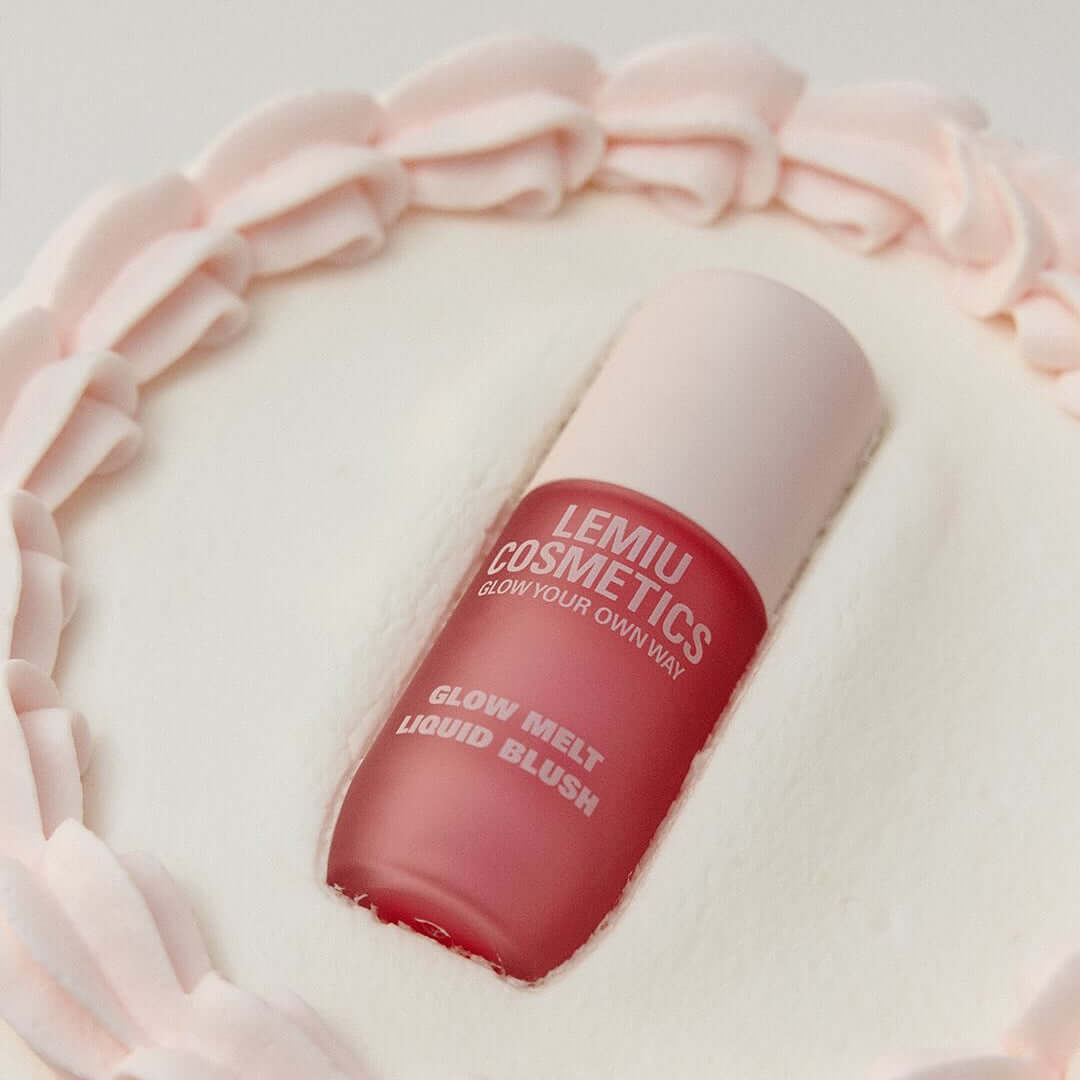 LEMIU Glow Melt Liquid Blush bottle in soft pink setting, showcasing the elegant cosmetic packaging and vibrant blush hue.