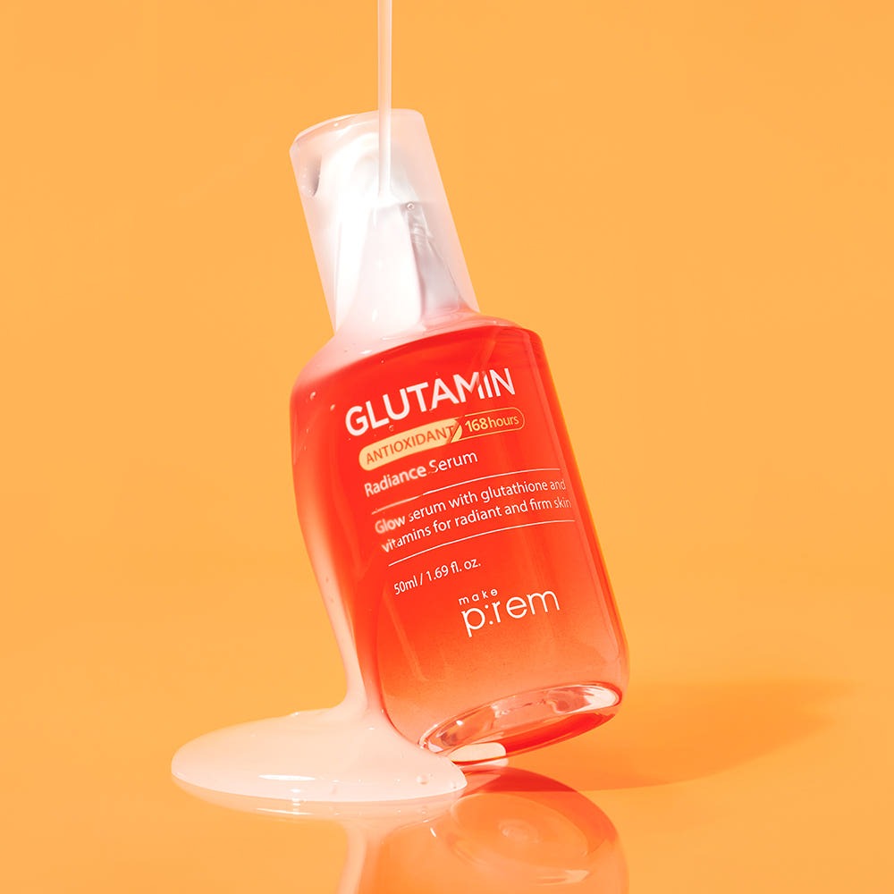 MAKE P:REM Glutamine Antioxidant Radiance Serum 50ml displayed against an orange background with liquid pouring over the bottle.