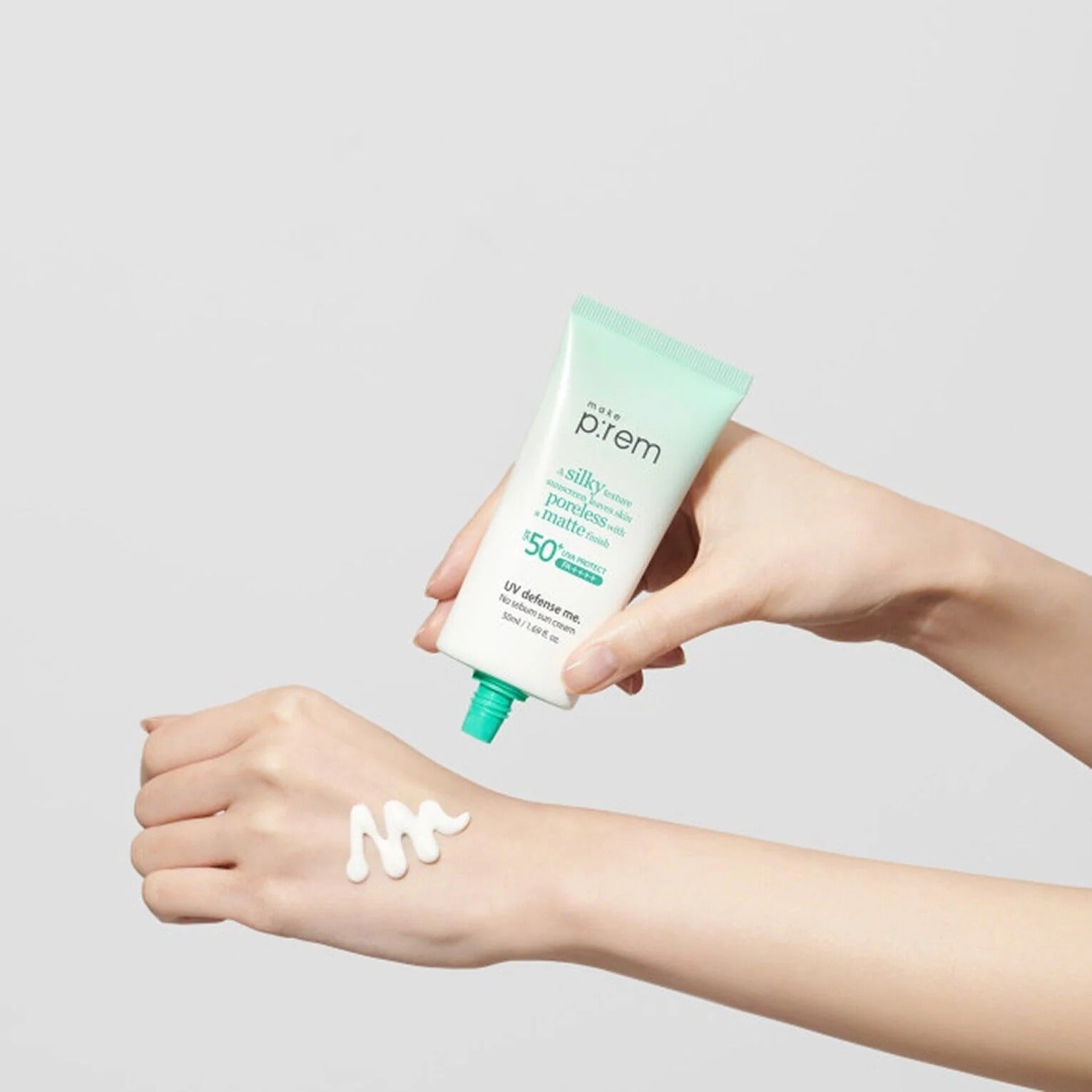 Person applying MAKE P:REM UV Defense Me No-Sebum Sunscreen 50ml on arm