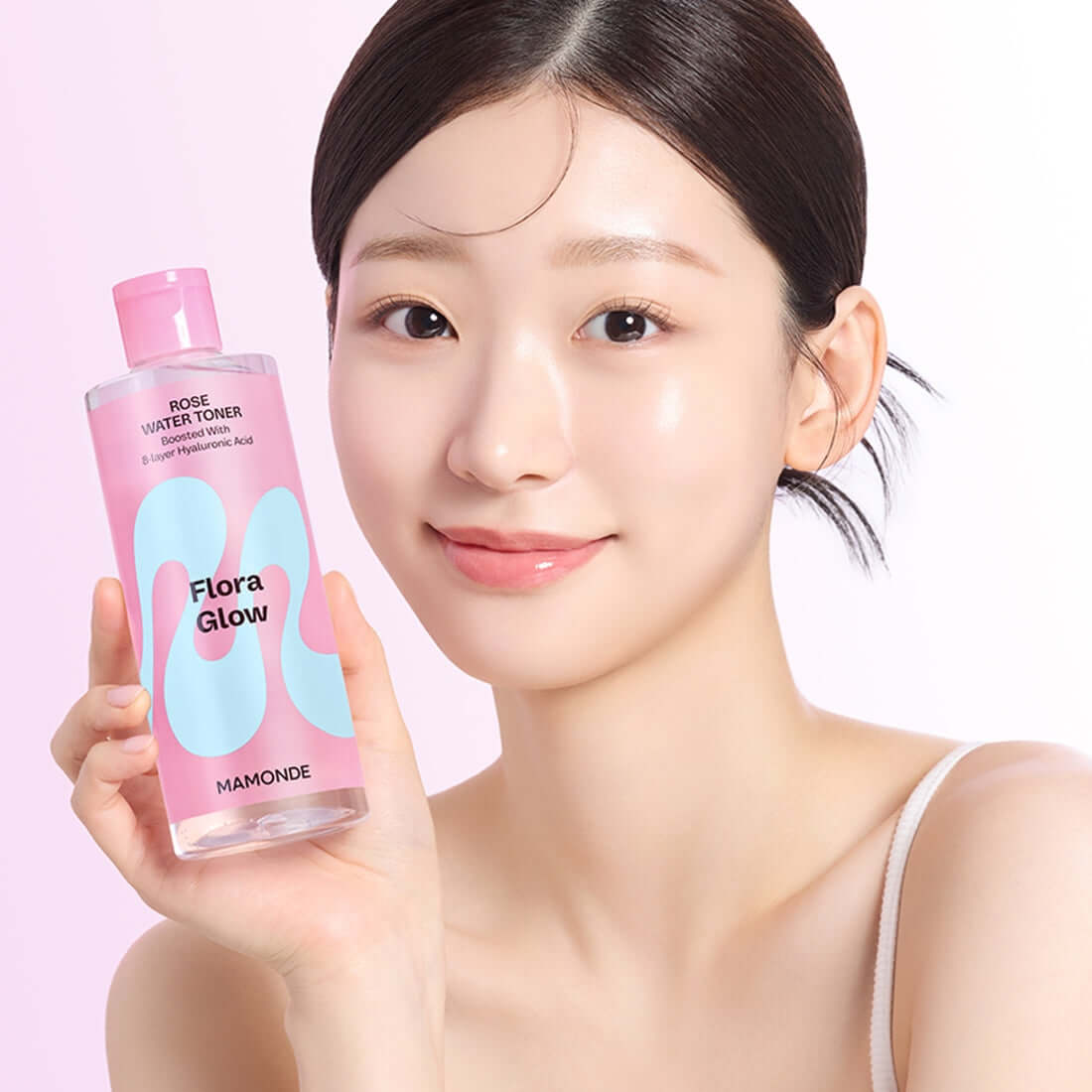 MAMONDE Flora Glow Rose Water Toner 300ml held by woman with clear skin glow.