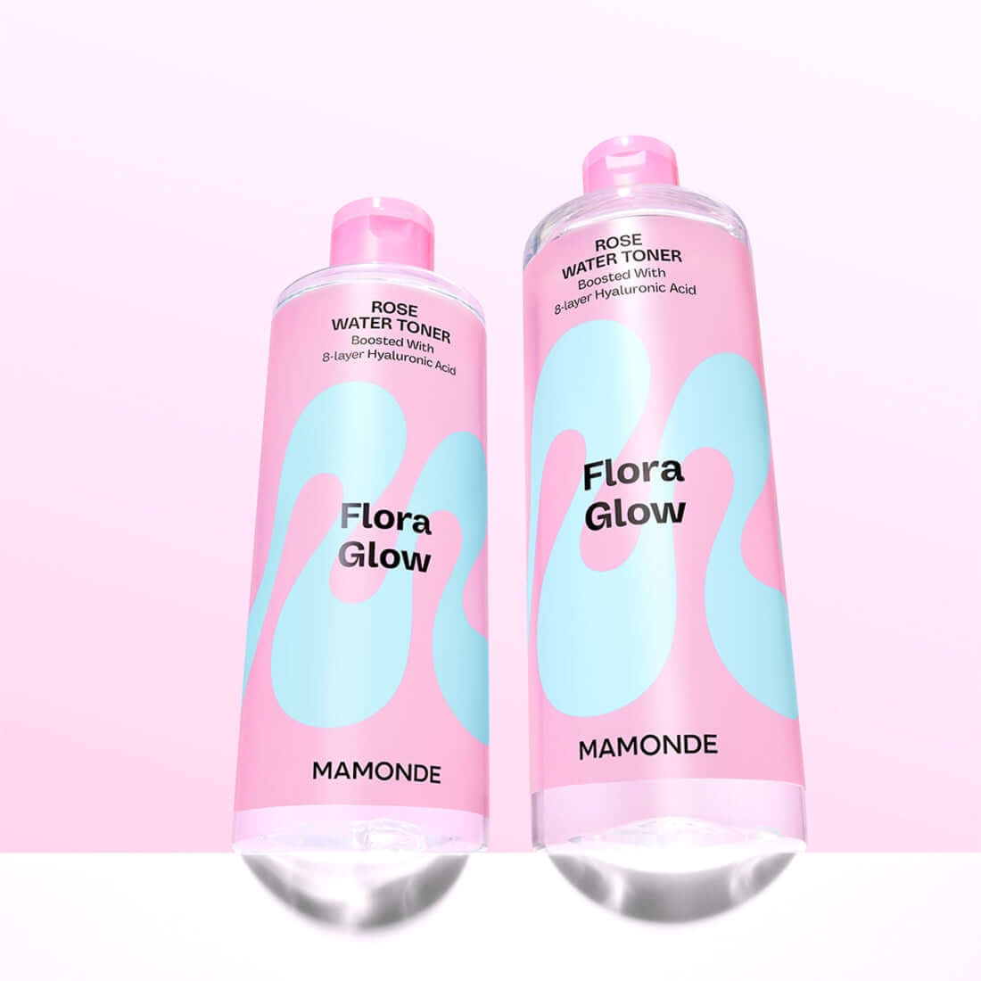 Two bottles of MAMONDE Flora Glow Rose Water Toner 300ml with pink and blue labels on a light background.