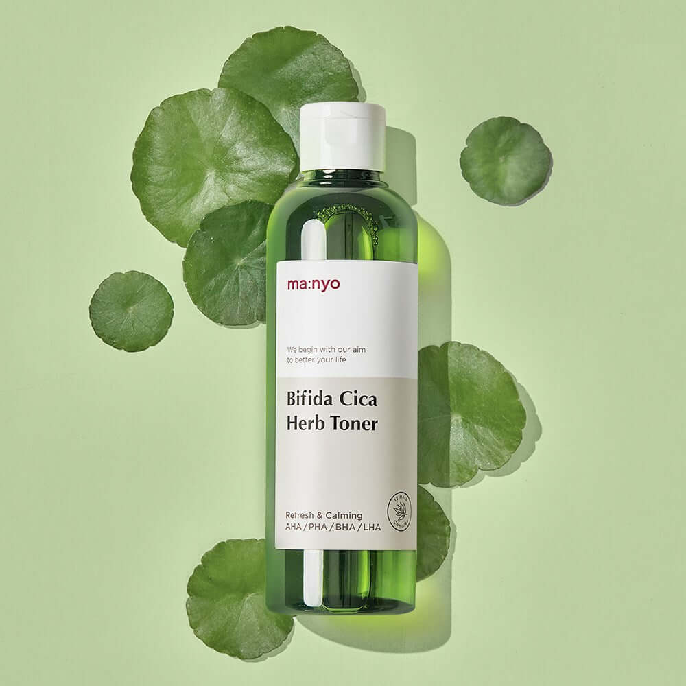 MANYO Bifida Cica Herb Toner 210ml bottle on a green leaf background