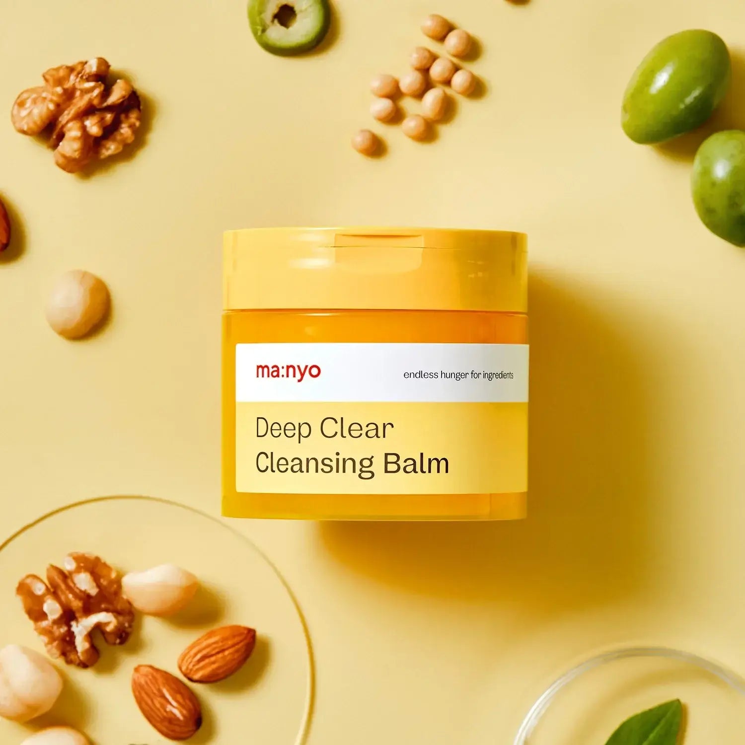 MANYO Deep Clear Cleansing Balm 132ml product image with natural ingredients on yellow background