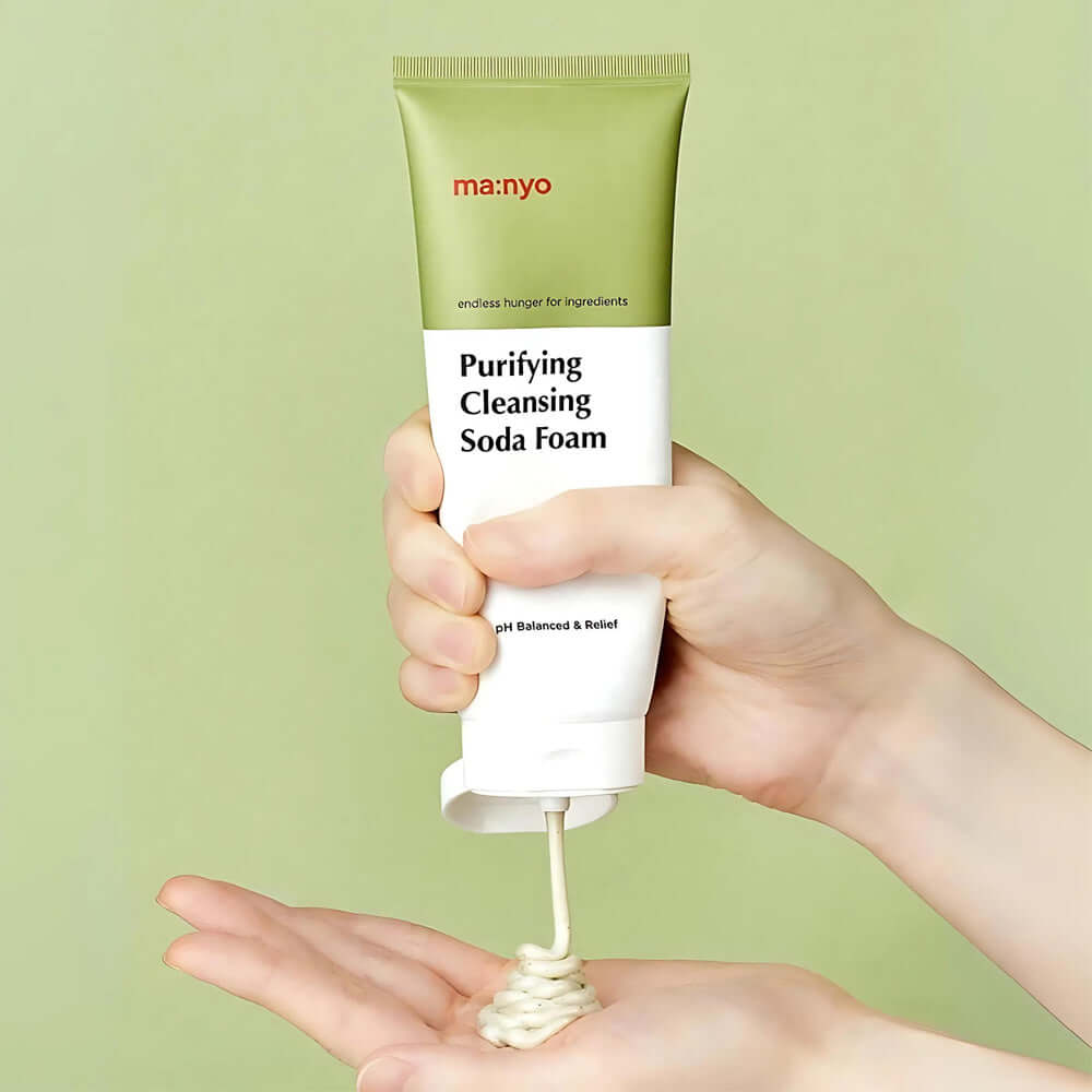 Person dispensing MANYO Deep Pore Cleansing Soda Foam 150ml from tube into hand