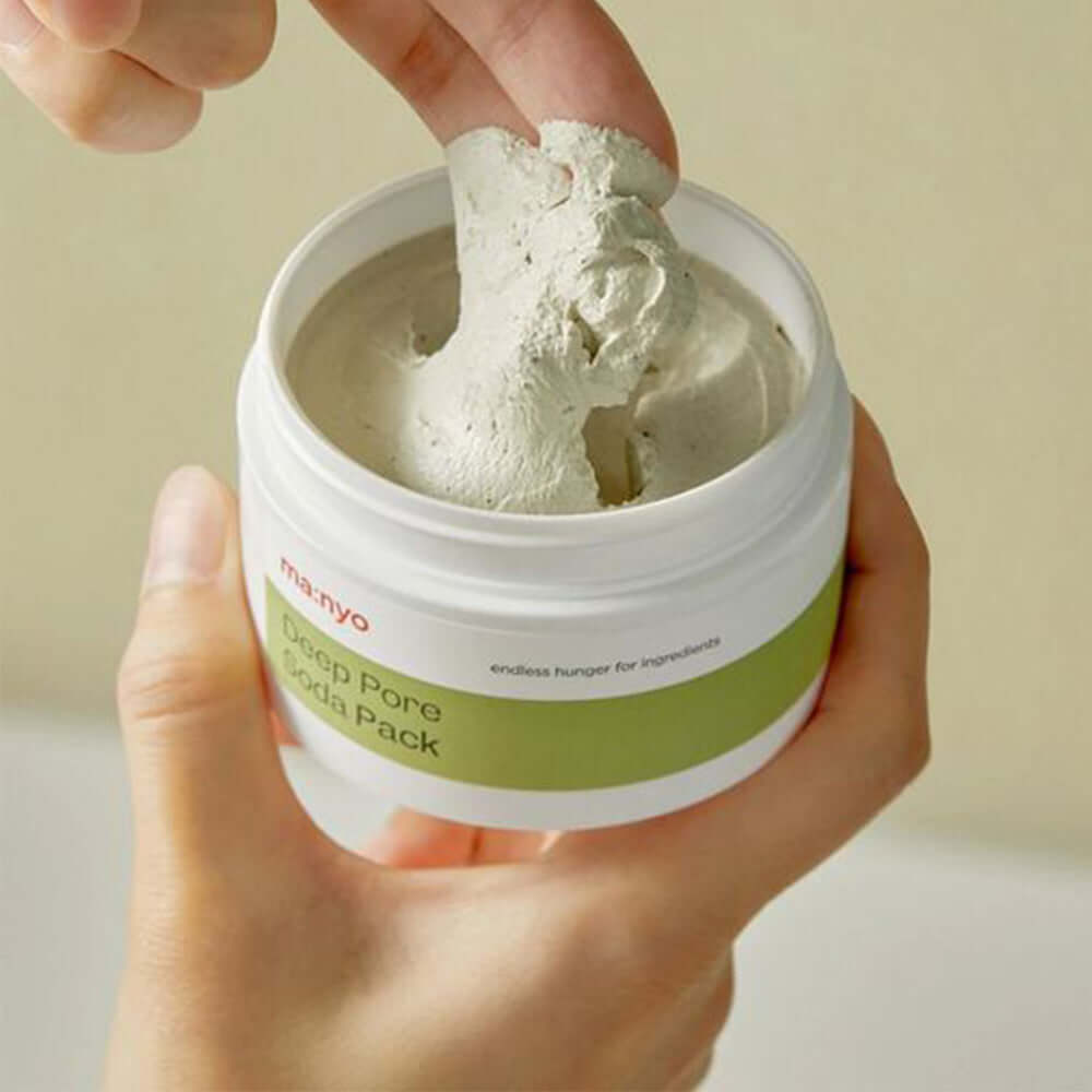 Hand applying MANYO Deep Pore Soda Pack 110ml for deep cleansing and skincare.