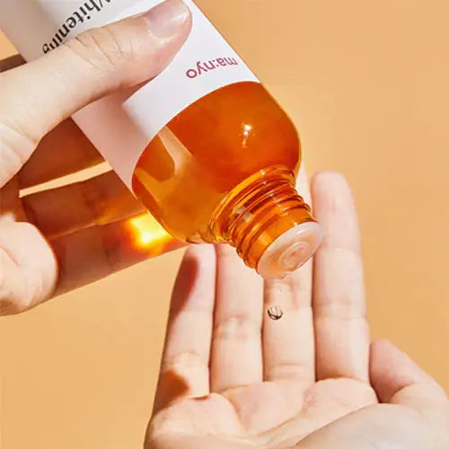 Person pouring MA:NYO V Galac Whitening Vita Toner 210ml into hand