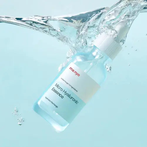 MANYO Micro Hyaluronic Essence 50ml bottle submerged in water, showcasing hydration and clarity for skincare enthusiasts.