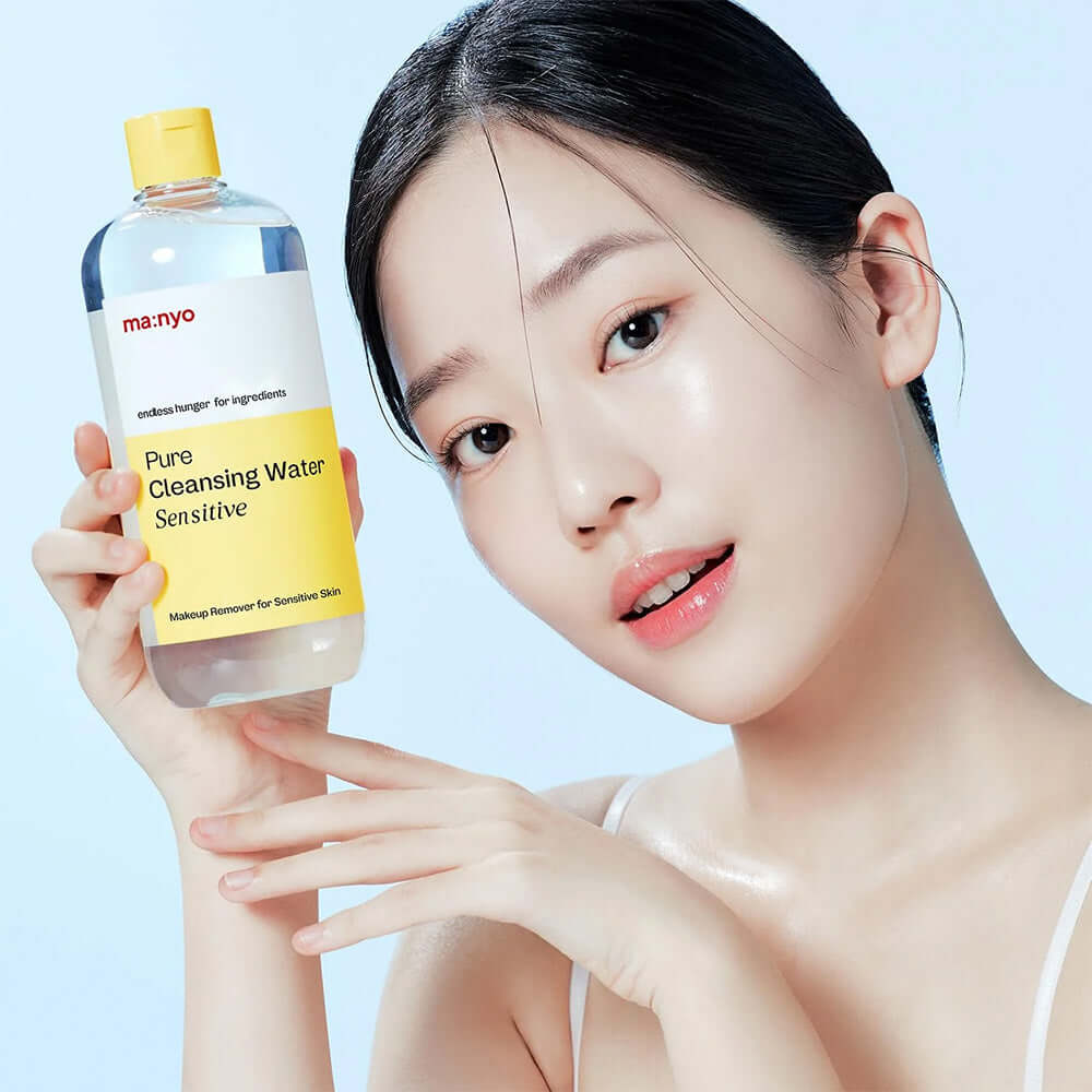 Woman holding MANYO Pore Cleansing Water Sensitive 500ml for sensitive skin cleansing